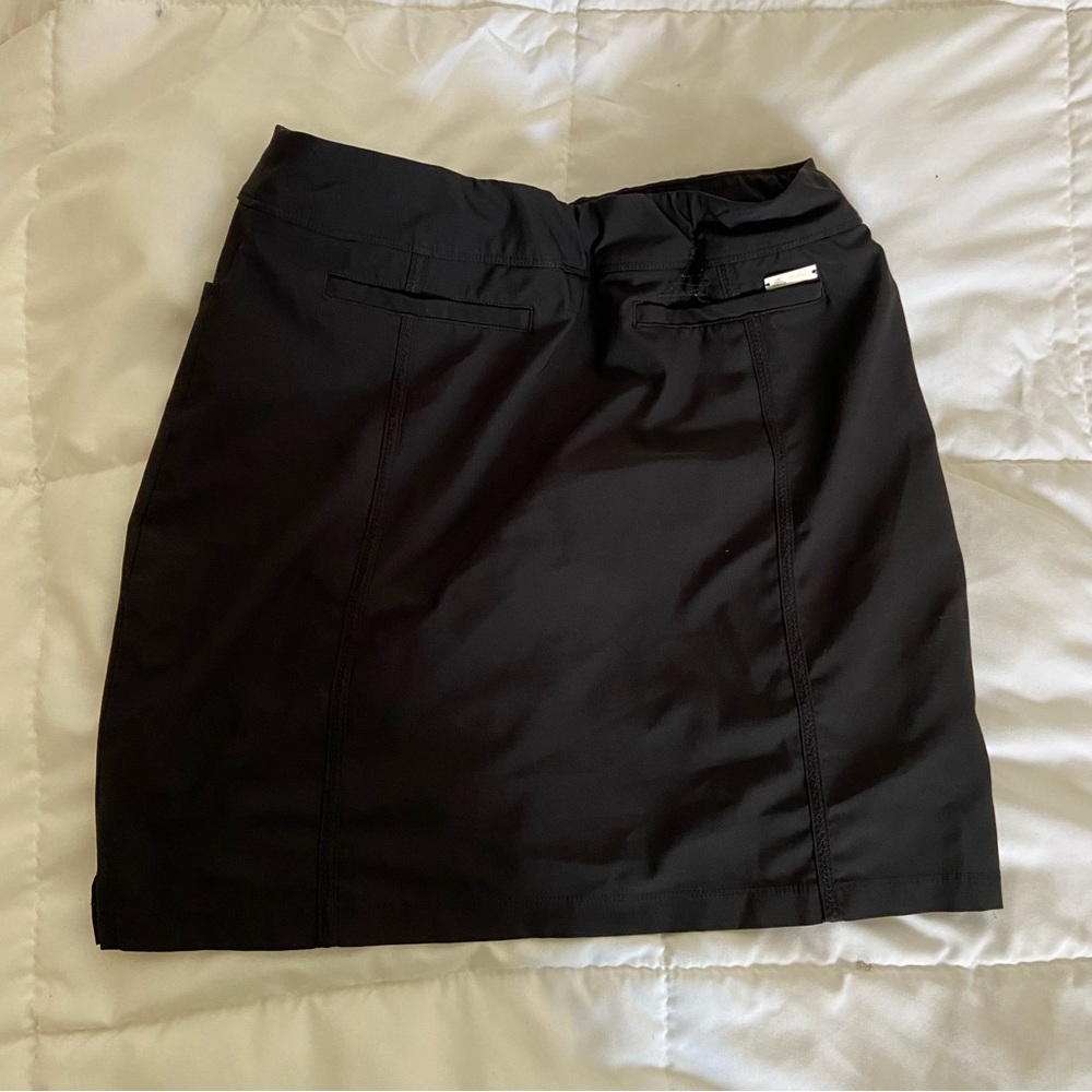 Adidas women’s golf skirt with shorts inside.